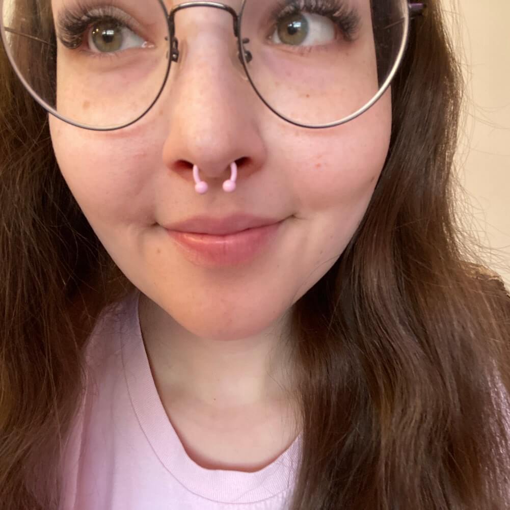 pink septum ring:rose-colored septum piercing